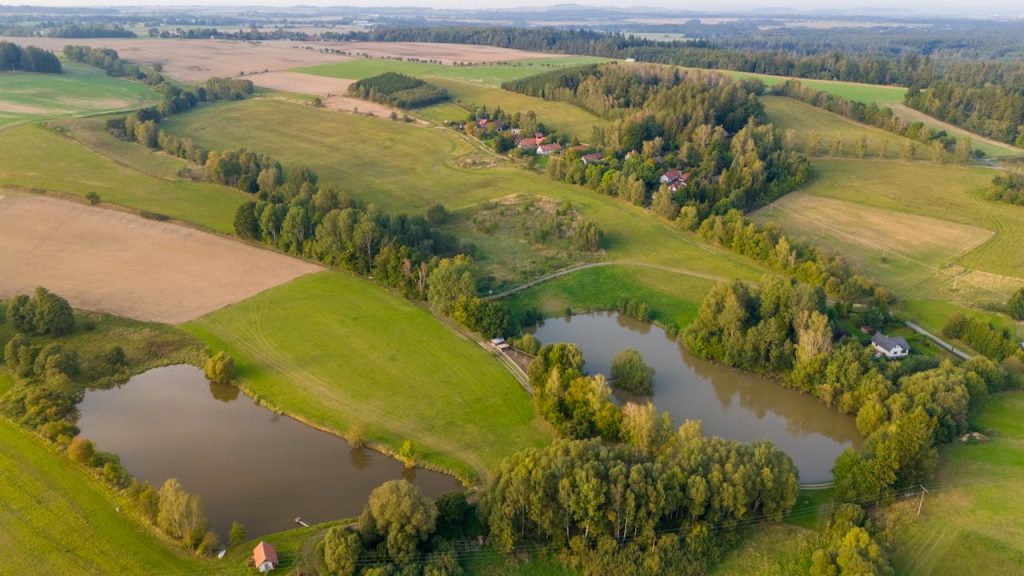 Scenic aerial landscape of the Czech countryside with lush greenery and lakes.